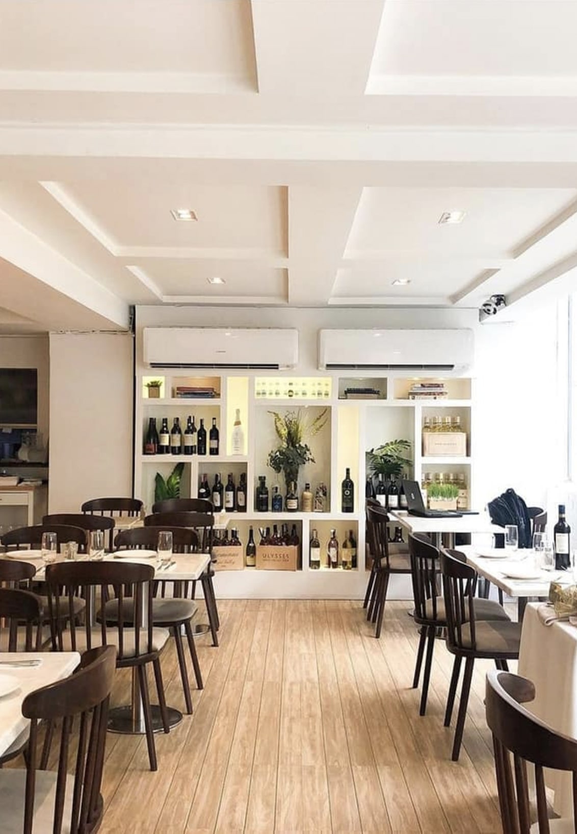 European-style interior of Sourdough Cafe with wine shelves and marble tables