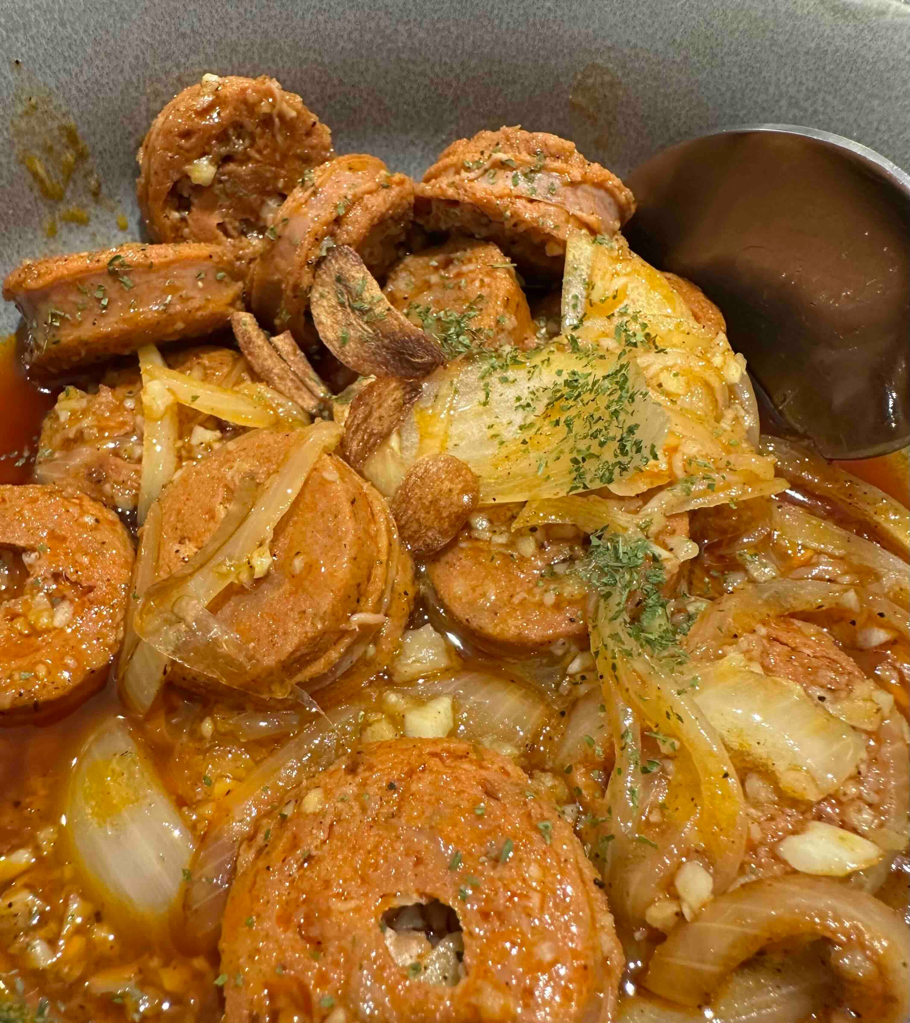 Sausage stew with onions and herbs